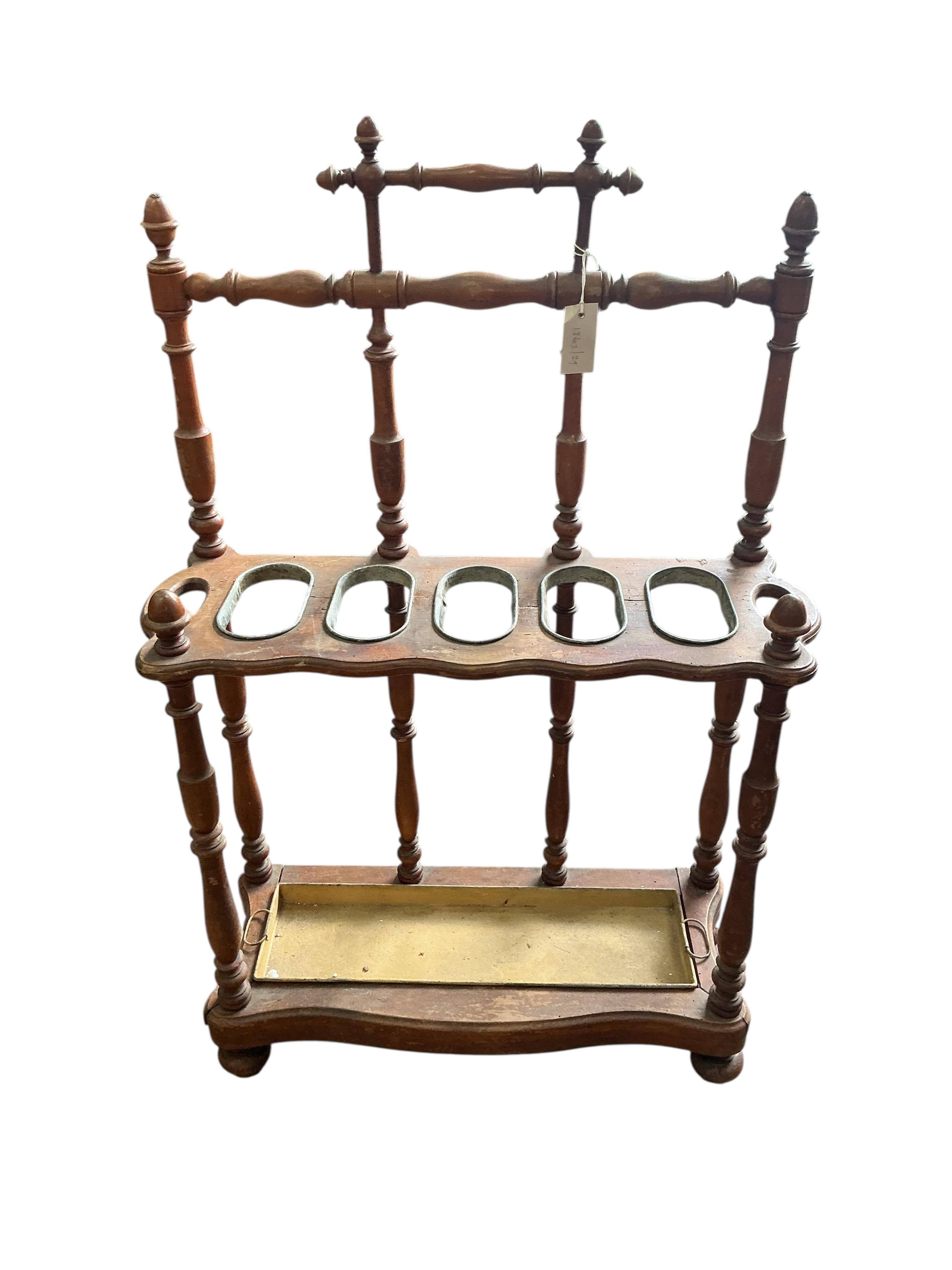 A late 19th / early 20th century French turned fruitwood five division stick stand, with tin drip tray, width 72cm, depth 28cm, height 112cm
